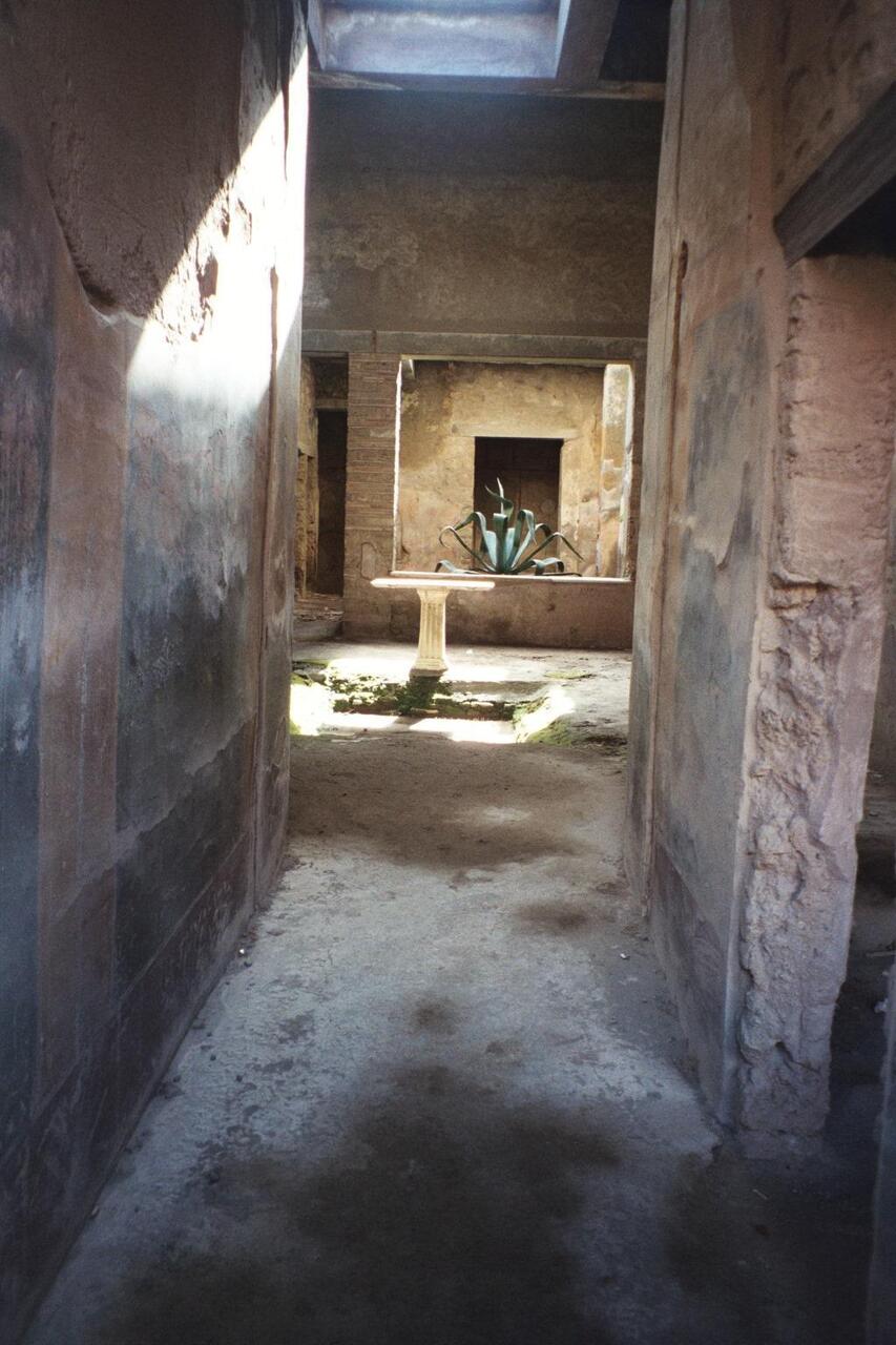 View of a fountain in an ancient courtyard in Pompeii.