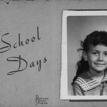 School Days in fancy script to the left of a partial bxw photo of a young girl with dark hair.